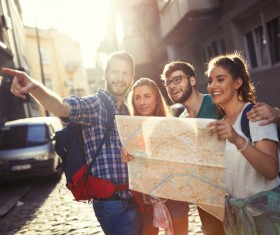 Happy tourists holding a map of the city