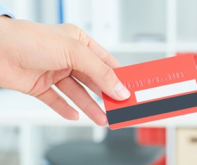 Holding a red credit card Stock Photo