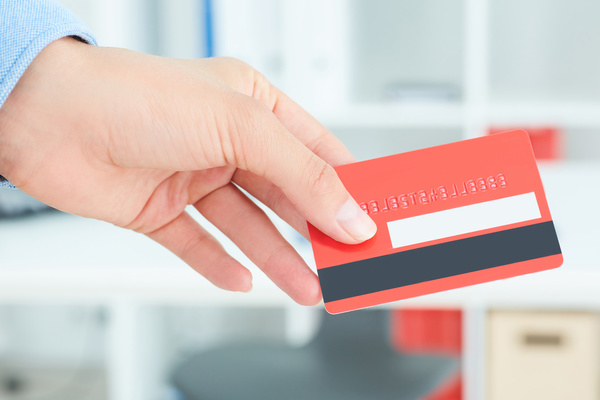 Holding a red credit card Stock Photo