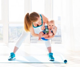 Holding the baby doing yoga young mother Stock Photo