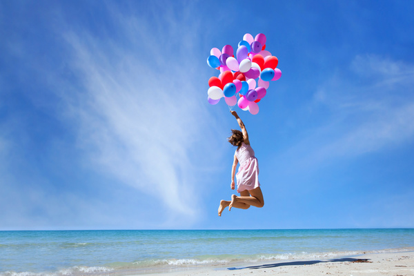 Jumping girl with balloons Stock Photo