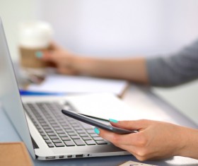 Look at cell phone information Business woman drinking coffee