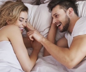 Lying in bed sweet couple Stock Photo