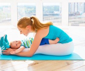 Lying on the legs of a fitness mother Stock Photo