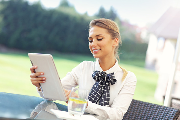 Outdoor resting woman using tablet HD picture