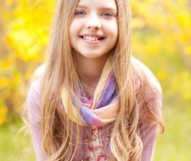 Pretty blonde little girl with autumn background