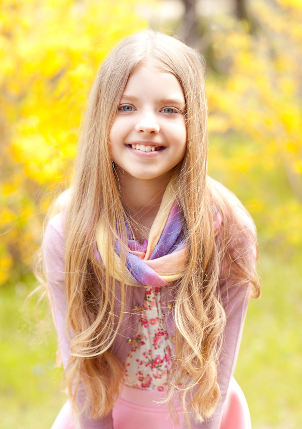 Pretty blonde little girl with autumn background