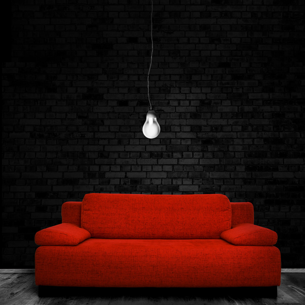 Red sofa chandelier with black brick wall