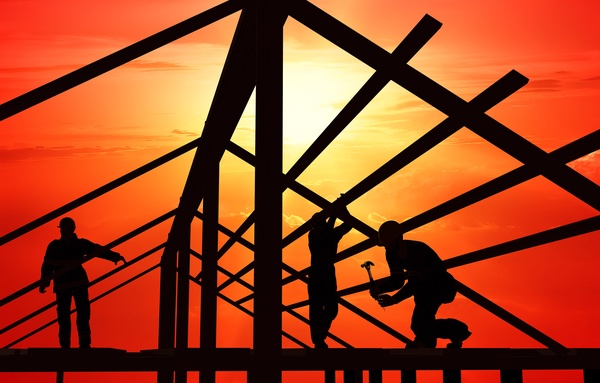 Red sun with construction worker Stock Photo