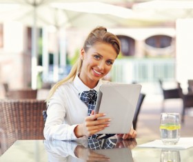 Smiling beautiful woman using a tablet PC HD picture