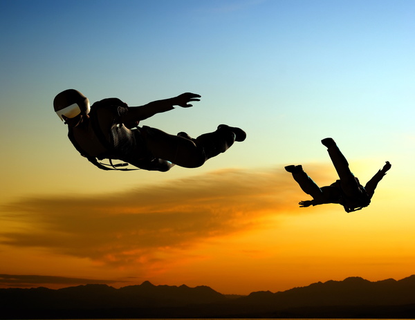 Sunset and skydiving athletes Stock Photo