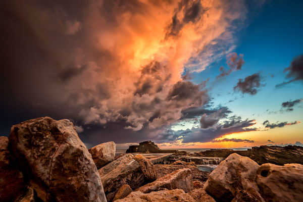 Sunset under the clouds coast reef Stock Photo