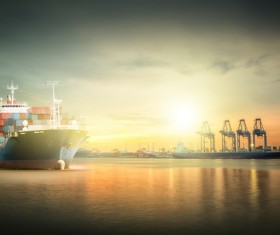 Sunset under the dock and sailing in the Cargo ships