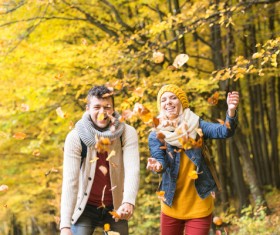 Sweet young couple throwing fallen leaves HD picture