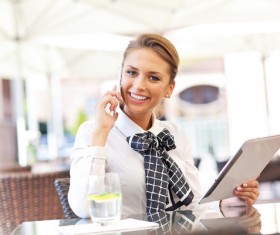 Take a Tablet PC Smiling beautiful woman with cell phone calls