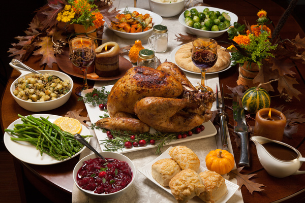 Thanksgiving dinner table rich roast turkey red wine and all kinds of vegetables