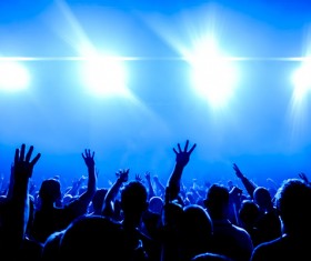 The blue light shines on the cheering crowd rock concert 01
