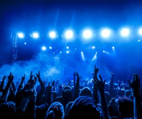 The blue light shines on the cheering crowd rock concert 02