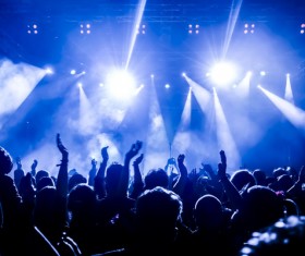 The blue light shines on the cheering crowd rock concert 03