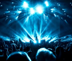 The blue light shines on the cheering crowd rock concert 04