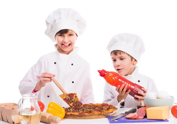 The children in the chef's uniform make food