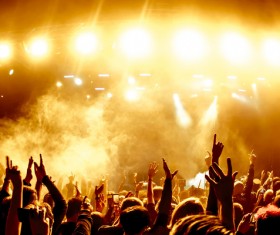 The rock concert cheered the crowd with yellow light smoke