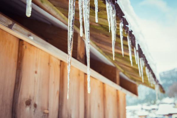 Under the eaves hanging icicles Stock Photo 01