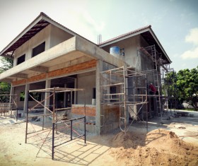 Unfinished villas with construction workers Stock Photo