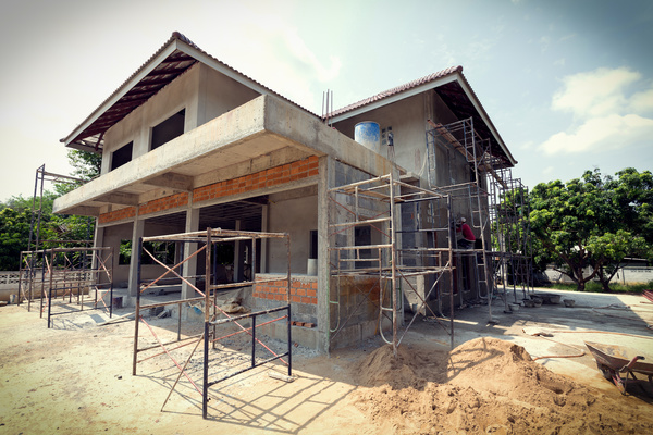 Unfinished villas with construction workers Stock Photo