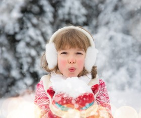 Winter girl playing with snow Stock Photo