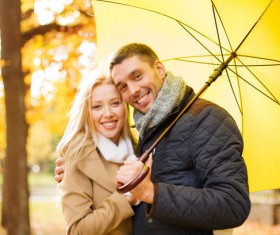 Yellow umbrella with smiling couple HD picture