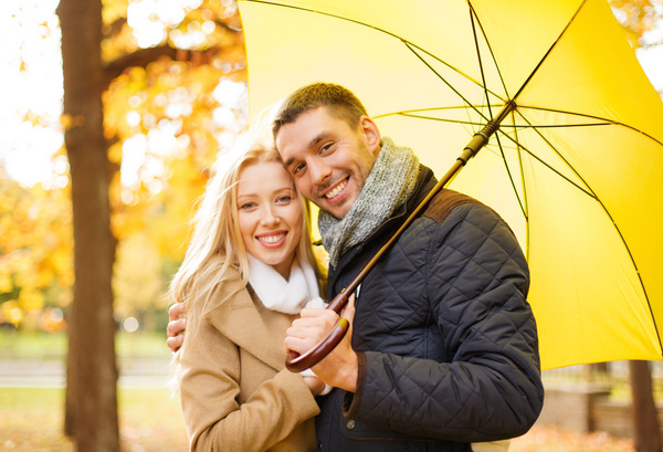 Yellow umbrella with smiling couple HD picture