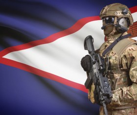 American Samoa Flag and Armed Soldier Stock Photo
