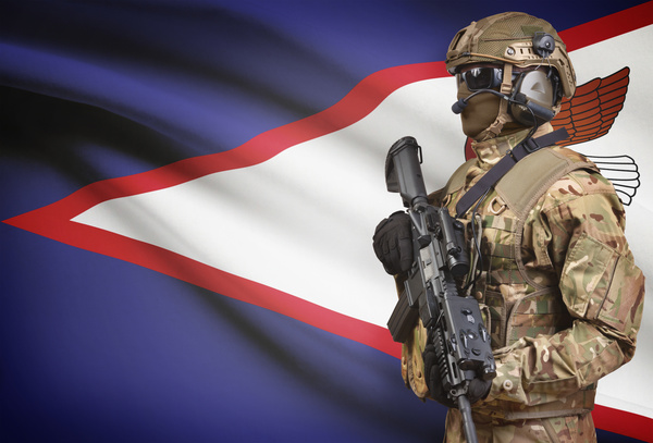 American Samoa Flag and Armed Soldier Stock Photo