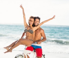 Beach Couple Cycling Stock Photo