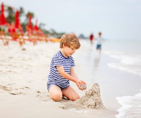 Beach boy playing with sand Stock Photo 01