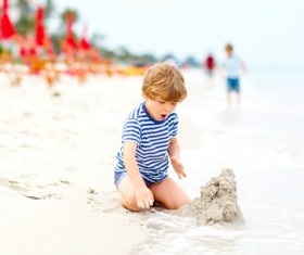 Beach boy playing with sand Stock Photo 02