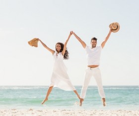 Beach couple jumping Stock Photo
