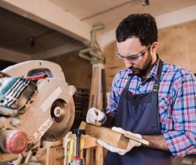 Carpenter draws the chain saw Stock Photo