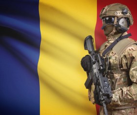 Chadian flag with heavily armed soldiers Stock Photo