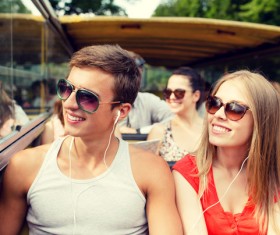 Couple listening to music on the bus Stock Photo