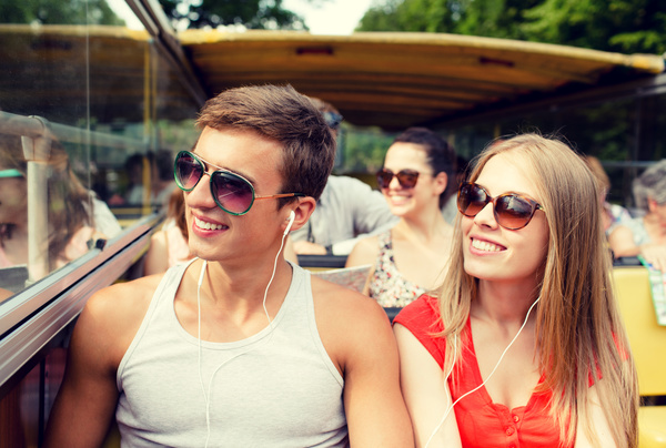 Couple listening to music on the bus Stock Photo