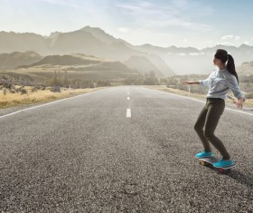 Girl playing skateboard on the highway HD picture