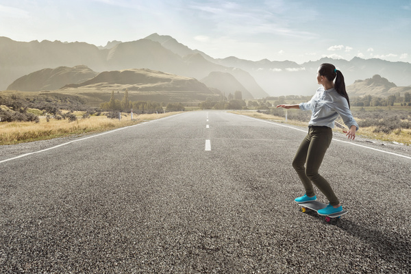 Girl playing skateboard on the highway HD picture