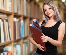 Library Young woman looking up information