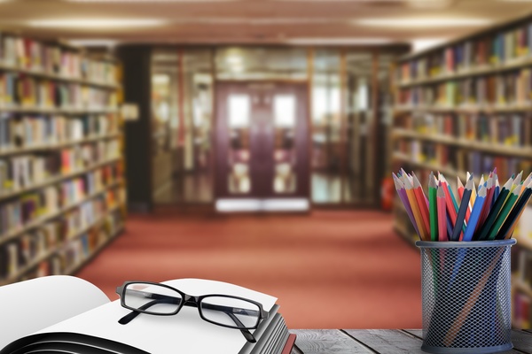 Library with desk pencil case with glasses Stock Photo 01