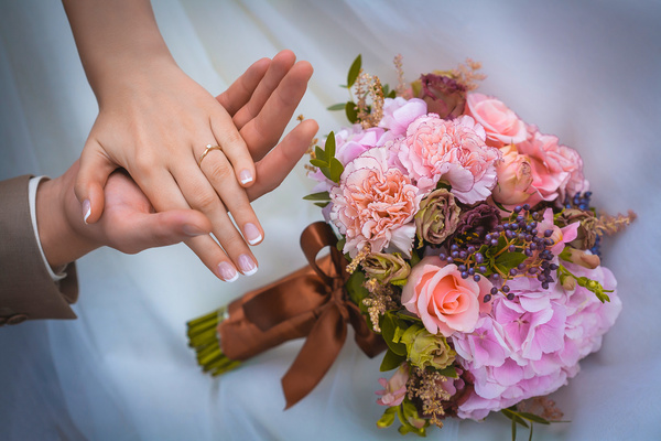 Newly married couple hand bouquet Stock Photo