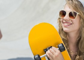 Smiling girl with skateboard HD picture