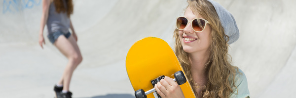 Smiling girl with skateboard HD picture