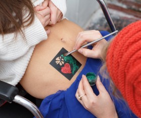 Tattoo on the belly of the female HD picture